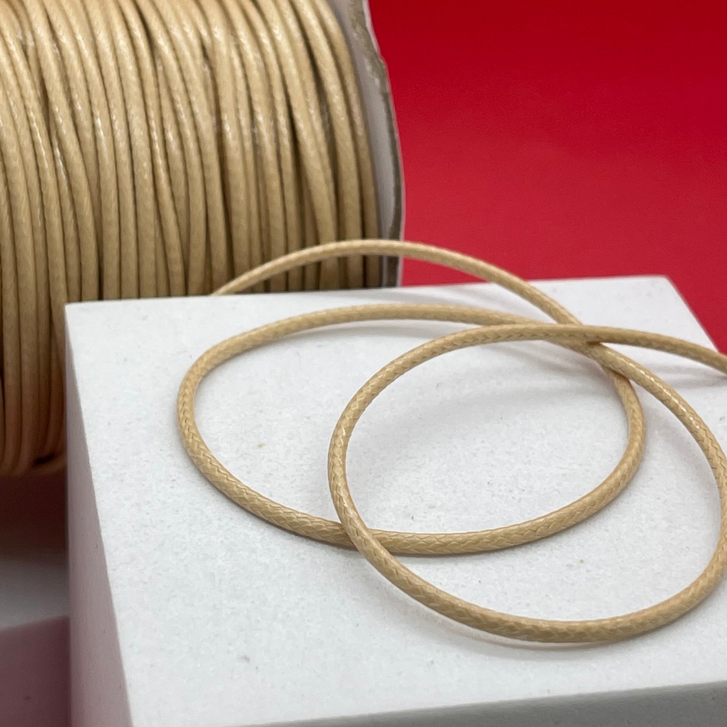 Material:Faux cord Dimension: 2mm Color: beige Quantity: 1 yarda SKU: 100665 The color may be different from the image due to different display devices and image alteration. This material is durable. To extend its longevity, avoid exposing it to water, lotions, perfumes, or any other chemicals.